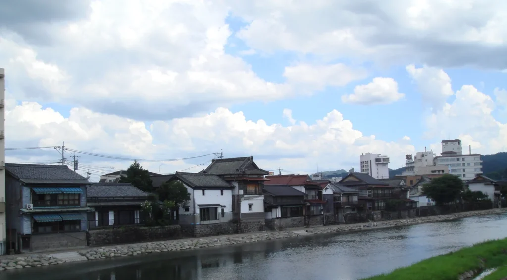 Old houses lining the bank of the Mikuma River in the Kuma district of Hita, Oita