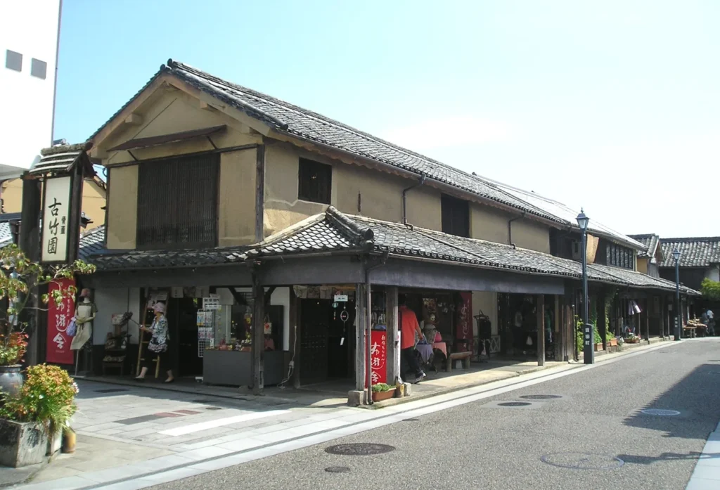 Two-storey wooden merchant houses with tiled roofs along a street in Mameda-machi, Hita, Oita
