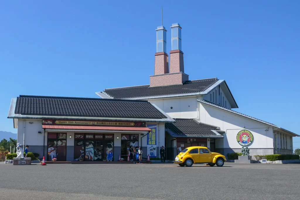 Museum building with twin brick chimneys and a yellow car parked outside, Hokuei, Tottori