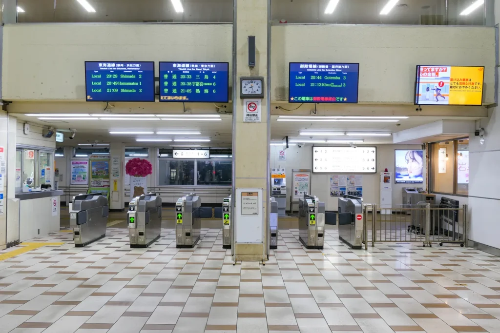 Ticket gates and departure boards inside JR Numazu Station