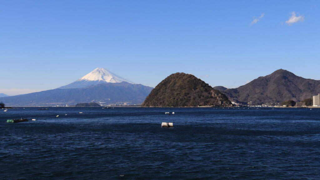 Snow-capped Mount Fuji beyond Awashima island across Uchiura Bay, Numazu