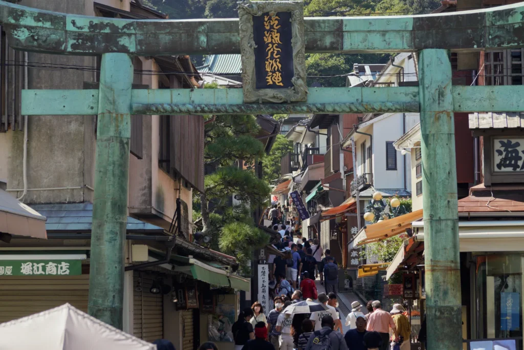 The bronze torii at the foot of the shopping street leading up to Enoshima Shrine