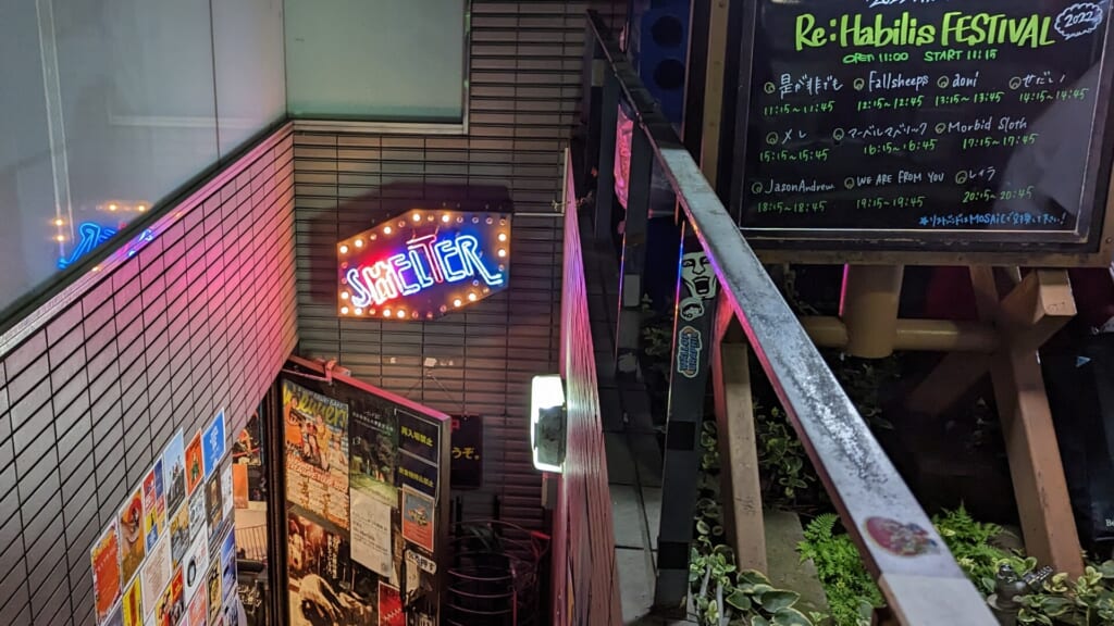 The neon SHELTER sign above the stairs down to the basement live house in Shimokitazawa