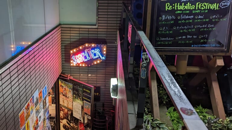 The neon SHELTER sign above the stairs down to the basement live house in Shimokitazawa