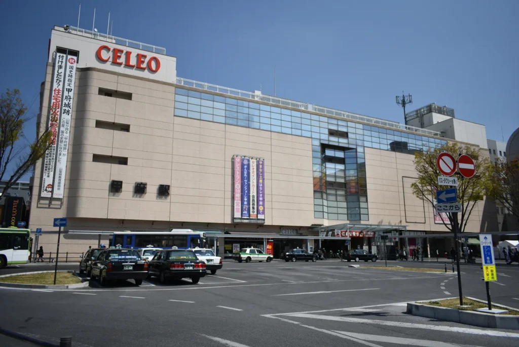 The south exit of Kofu Station with the station building and taxi rank