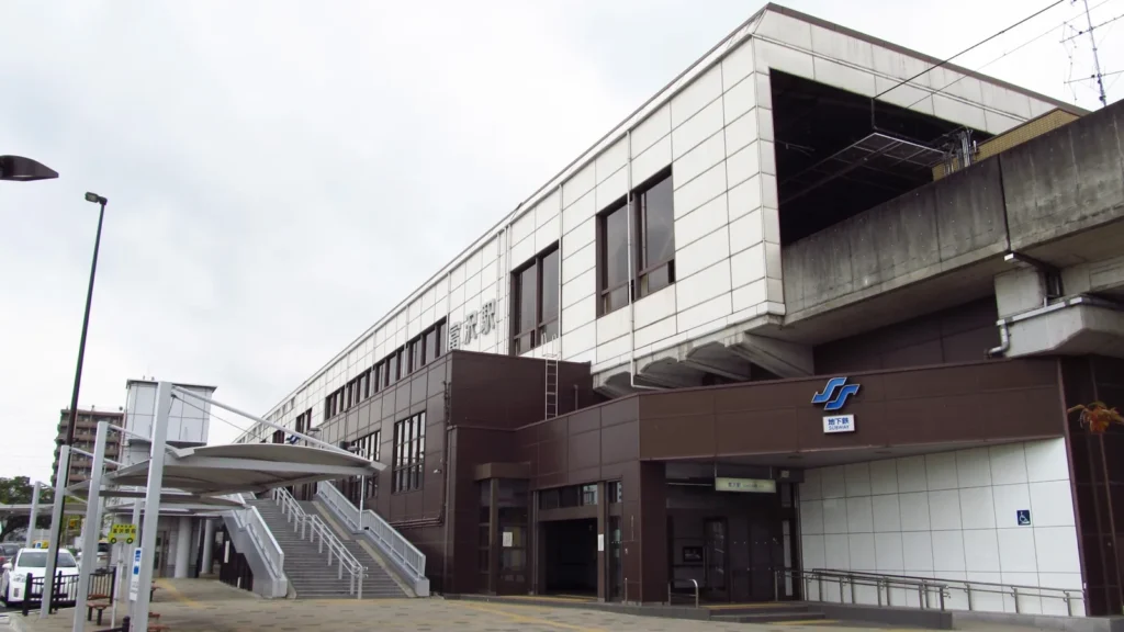 The elevated building of Tomizawa subway station in Sendai, with stairs and a covered walkway in front